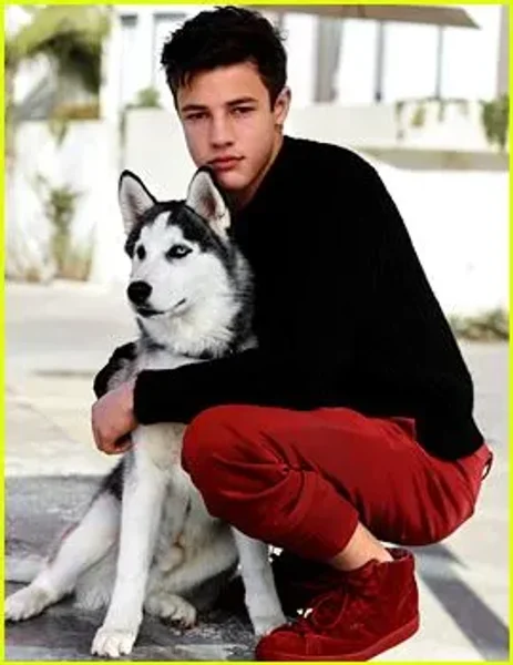 Cameron Dallas poses with his new dog Jaxx during his photo shoot for the Just Jared Spotlight Series.