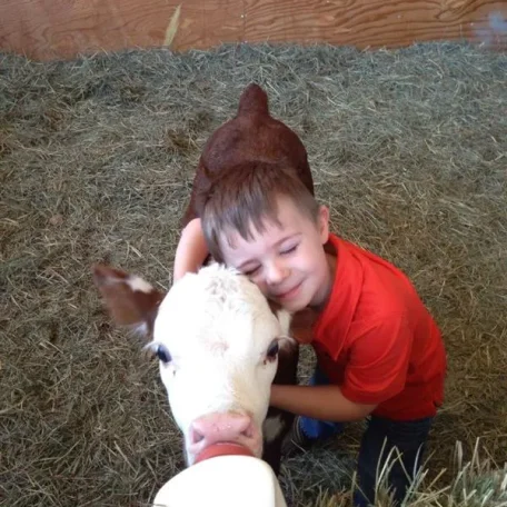 What a touching and sweet photo of a Boy and an orphan calf!