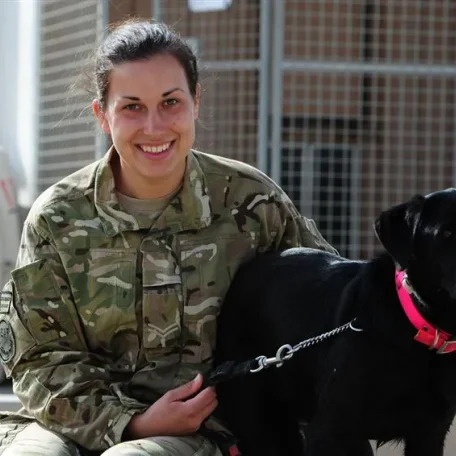Charlotte Archer, 24, from Melton Mowbray with her black Labrador named Fire, at the dog kennels on Camp Bastion in Afghanistan. The kennels at Camp Bastion are equipped with a vet's surgery complete with operating theatre, as well as a pool for cooling