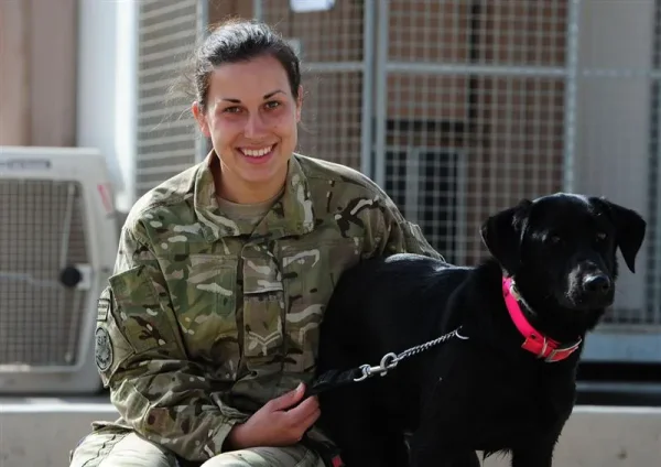 Charlotte Archer, 24, from Melton Mowbray with her black Labrador named Fire, at the dog kennels on Camp Bastion in Afghanistan. The kennels at Camp Bastion are equipped with a vet's surgery complete with operating theatre, as well as a pool for cooling