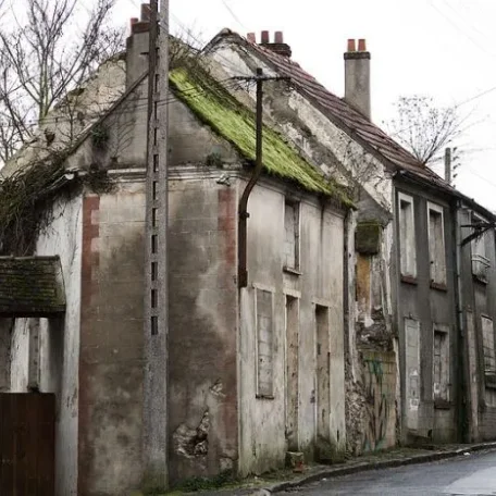 A quiet lane of old houses now small factories